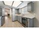 Modern kitchen featuring stainless steel refrigerator, wine cooler and light blue cabinets at 5725 Cedar Ave, Las Vegas, NV 89110