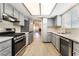 Kitchen featuring stainless steel appliances, gray cabinets, and hardwood floors at 5725 Cedar Ave, Las Vegas, NV 89110