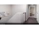Bright upstairs hallway leading to rooms with carpet and contemporary railing at 620 Bellus Pl # Lot 168, Henderson, NV 89015