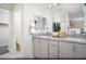 Primary bathroom featuring double vanities, granite countertops, and a well-lit mirror at 624 Bellus Pl # Lot 170, Henderson, NV 89015