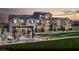 Beautiful multi-story townhomes with modern architecture, front lawns, and outdoor seating areas, perfect for community living at 624 Bellus Pl # Lot 170, Henderson, NV 89015