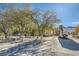 Spacious property featuring a well-maintained lawn, mature trees, and a horse trailer at 6325 Guy Ave Ave, Las Vegas, NV 89131