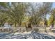 Charming single-story home with mature trees, desert landscaping, and a white fence at 6325 Guy Ave Ave, Las Vegas, NV 89131
