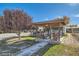 Outdoor gazebo with seating area, offering a relaxing space surrounded by trees and greenery at 6325 Guy Ave Ave, Las Vegas, NV 89131