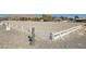 Full view of a horse dressage arena with white fencing and landscaped borders at 6325 Guy Ave Ave, Las Vegas, NV 89131