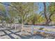 Scenic view of gated property with mature trees along the driveway at 6325 Guy Ave Ave, Las Vegas, NV 89131