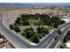 Aerial view of a park area, surrounded by desert landscape and roadways at 652 Del Prado Dr, Boulder City, NV 89005