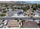 Expansive aerial view of a modern two story home with desert landscaping in a tranquil suburban neighborhood at 652 Del Prado Dr, Boulder City, NV 89005