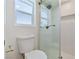 Modern bathroom with a glass-enclosed shower, white tile, and a bright, clean aesthetic at 652 Del Prado Dr, Boulder City, NV 89005