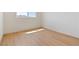 Sunlit bedroom featuring sleek light wood flooring and baseboards at 652 Del Prado Dr, Boulder City, NV 89005