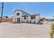 A white 2-story home with black trim, dual-pane windows, and minimal landscaping at 652 Del Prado Dr, Boulder City, NV 89005