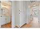 Hallway with bathroom view, storage, and light wood flooring at 652 Del Prado Dr, Boulder City, NV 89005