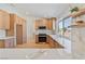 Modern kitchen with light wood cabinets, stone countertops, and stainless steel appliances at 652 Del Prado Dr, Boulder City, NV 89005