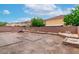 A view of the backyard that features a rock landscape design with a firepit in the center at 6558 Musette Ave, Las Vegas, NV 89139