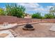An outdoor fire pit provides a central focal point, surrounded by a rock and planter landscape design at 6558 Musette Ave, Las Vegas, NV 89139
