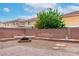 View of the backyard that includes a fire pit, brick pavers, and decorative rock landscape features at 6558 Musette Ave, Las Vegas, NV 89139