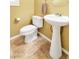 Cozy bathroom with toilet, pedestal sink and decorative tile flooring at 6558 Musette Ave, Las Vegas, NV 89139