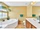 Bright bathroom features double sinks, a soaking tub, and natural light at 6558 Musette Ave, Las Vegas, NV 89139