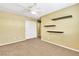 Bedroom featuring floating shelves, double closet, neutral walls, and carpet at 6558 Musette Ave, Las Vegas, NV 89139