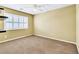Bedroom featuring plantation shutters, ceiling fan, and wall-mounted shelves at 6558 Musette Ave, Las Vegas, NV 89139