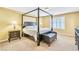 Bedroom featuring a four poster bed, two side tables and carpet flooring at 6558 Musette Ave, Las Vegas, NV 89139