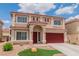Two-story home with a red roof, red garage doors, and manicured lawn at 6558 Musette Ave, Las Vegas, NV 89139