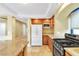 Open concept kitchen with stainless steel oven, tile floor, recessed lights, and wooden cabinets at 6558 Musette Ave, Las Vegas, NV 89139