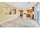 Spacious kitchen with island, tile floors opens to dining area and backyard access at 6558 Musette Ave, Las Vegas, NV 89139