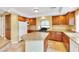 Bright kitchen with granite island, tile floor, stainless steel appliances, and recessed lighting at 6558 Musette Ave, Las Vegas, NV 89139