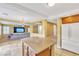 Open concept kitchen with island and stainless steel refrigerator flows into living area at 6558 Musette Ave, Las Vegas, NV 89139