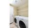 Well-lit laundry room featuring white appliances and wire shelving for organized storage at 6558 Musette Ave, Las Vegas, NV 89139