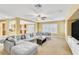 Bright living room features a large sectional sofa, ceiling fan, and an open floorplan at 6558 Musette Ave, Las Vegas, NV 89139