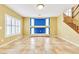 Living room with a staircase, yellow walls and tile flooring throughout at 6558 Musette Ave, Las Vegas, NV 89139