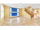 Open living space with tile flooring, staircase, and yellow walls at 6558 Musette Ave, Las Vegas, NV 89139