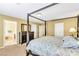 This main bedroom features a four-poster bed and an ensuite bathroom at 6558 Musette Ave, Las Vegas, NV 89139