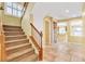 Carpeted staircase leading to the upper level, with view of entry and kitchen at 6558 Musette Ave, Las Vegas, NV 89139