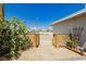 Backyard entrance with a wooden fence, desert landscaping, and gravel at 67 Oklahoma Dr, Henderson, NV 89015