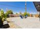 Inviting backyard patio features a brick paved area, fire pit, comfortable chairs, and blooming garden at 67 Oklahoma Dr, Henderson, NV 89015
