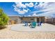 Relaxing backyard patio with brick pavers, fire pit, Adirondack chairs, pergola and lovely desert landscaping at 67 Oklahoma Dr, Henderson, NV 89015