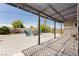 Charming backyard patio area featuring a pergola, paved brick, fire pit, and colorful Adirondack chairs at 67 Oklahoma Dr, Henderson, NV 89015