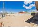 Spacious backyard with a dirt area, concrete block fence and steps up to the house at 67 Oklahoma Dr, Henderson, NV 89015