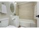Bright bathroom featuring a tiled shower, vanity, and a decorative mirror at 67 Oklahoma Dr, Henderson, NV 89015