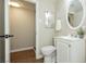 Bright bathroom featuring a white vanity, toilet, mirror, and neutral wall color at 67 Oklahoma Dr, Henderson, NV 89015