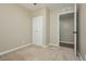Neutral bedroom featuring carpeted floors, trim, and an attached closet and bathroom at 67 Oklahoma Dr, Henderson, NV 89015