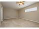 Spacious bedroom with neutral carpet, a ceiling fan, and bright natural light at 67 Oklahoma Dr, Henderson, NV 89015