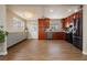 Updated kitchen with stainless steel appliances, cherry cabinets, and tile flooring, creating an open floor plan at 67 Oklahoma Dr, Henderson, NV 89015