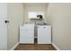 Laundry room featuring a modern side by side washer and dryer, tiled flooring and neutral paint at 67 Oklahoma Dr, Henderson, NV 89015