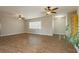 Spacious living room featuring three ceiling fans, tile flooring, and neutral walls at 67 Oklahoma Dr, Henderson, NV 89015