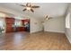 Open-concept living room and kitchen with stainless steel appliances and wood-look tile flooring at 67 Oklahoma Dr, Henderson, NV 89015