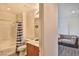 This bathroom offers a shower and tub combo, toilet, and vanity next to a living area at 6739 Twisted Wood Dr, Las Vegas, NV 89148